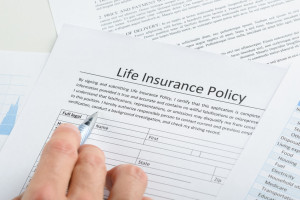 Person Filling Application For Life Insurance