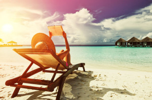 Young woman reading a book at beach